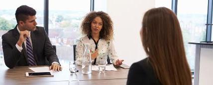 Two people interviewing a job candidate.